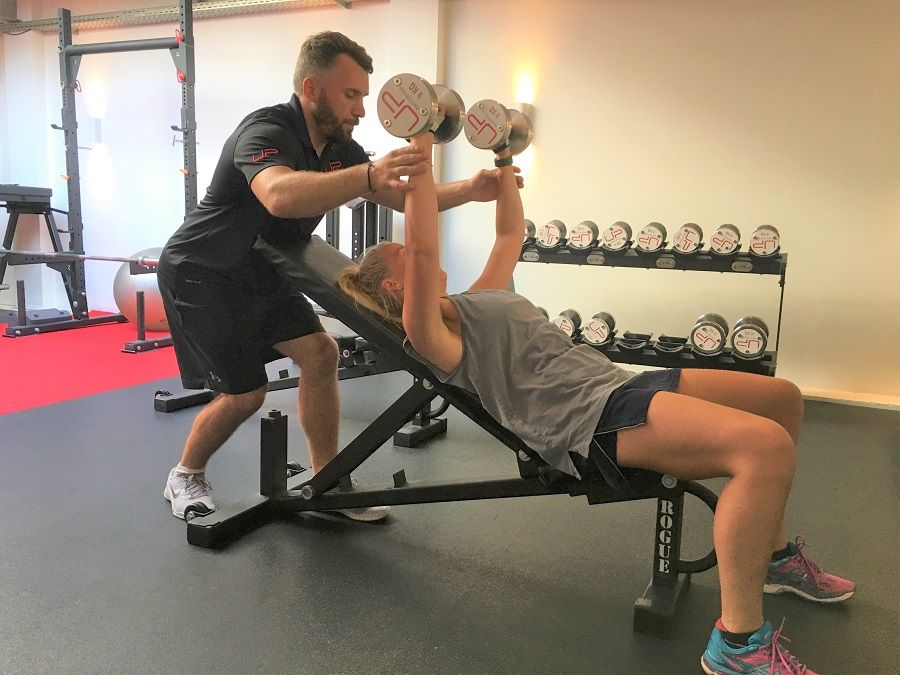 Estelle-in-the-gym-dumbbells-900-web | Ultimate Performance